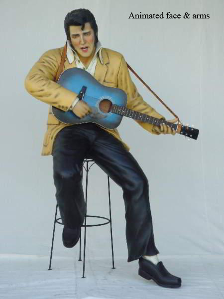 Robotics Elvis Presley sitting on stool playing guitar